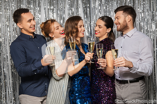 Image of happy friends toasting champagne glasses at party