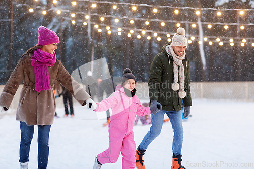 Image of happy family at outdoor skating rink in winter