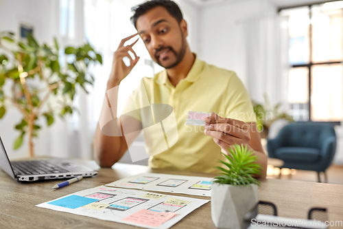 Image of ui designer working on user interface at home