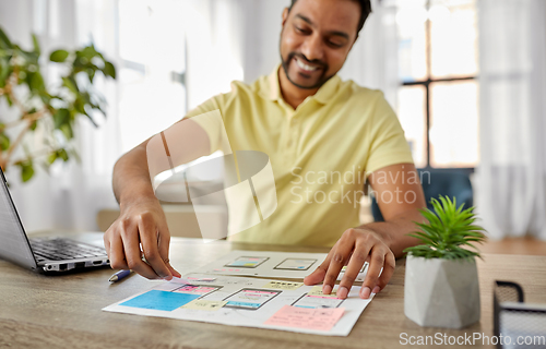 Image of ui designer working on user interface at home