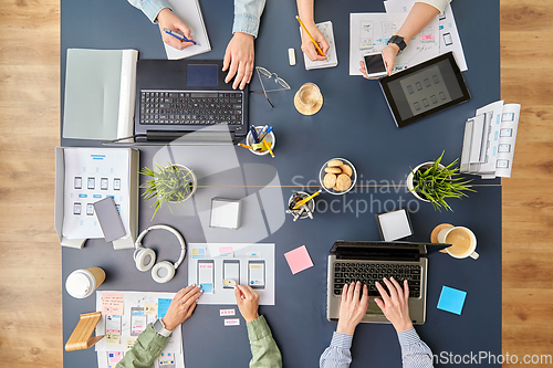 Image of business team with gadgets working at office table