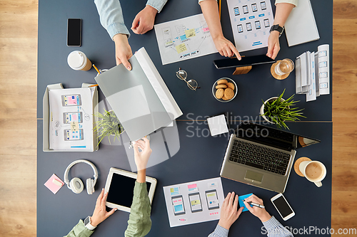 Image of business team with gadgets working at office table