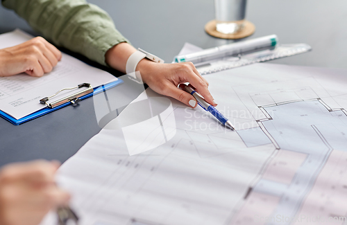 Image of architect with blueprint working at office