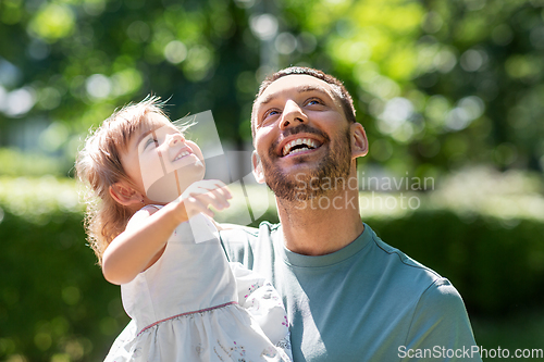 Image of happy father with baby daughter at summer park