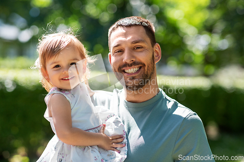 Image of happy father with baby daughter at summer park