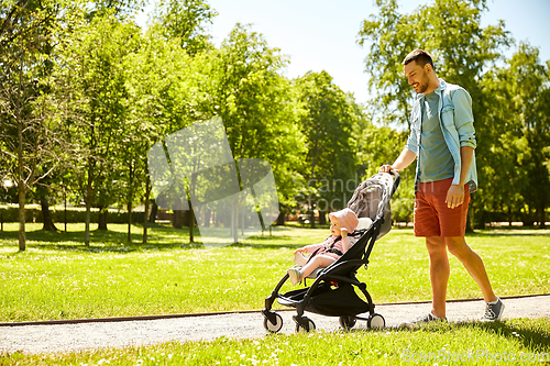 Image of happy father with child in stroller at summer park