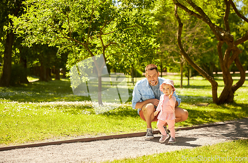 Image of happy father with baby daughter at summer park