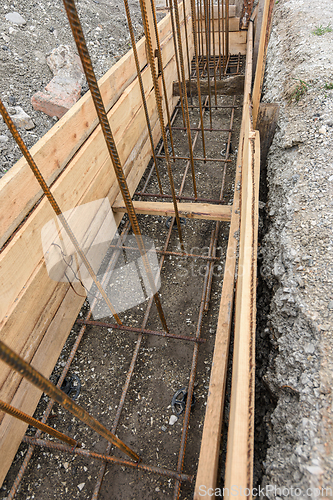 Image of Reinforcement of the strip foundation, lower layer of reinforcement, unfinished formwork