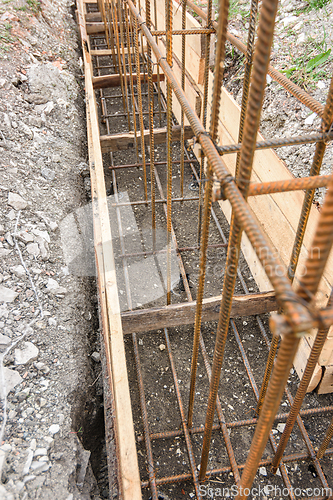 Image of Reinforcement of the strip foundation with metal reinforcement in a trench with formwork