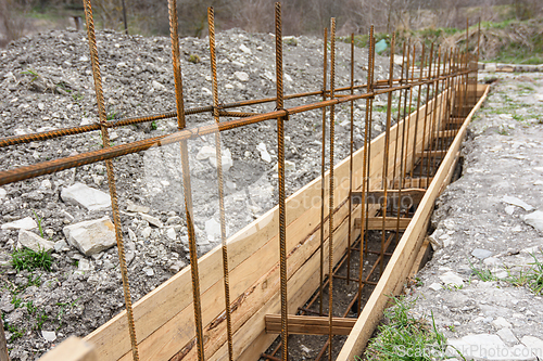 Image of Reinforcement of the strip foundation with metal reinforcement, the top row of reinforcement is in focus