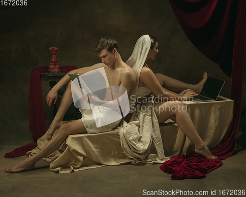 Image of Modern remake of classical artwork with modern tech theme - young medieval couple on dark background