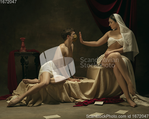 Image of Modern remake of classical artwork with coronavirus theme - young medieval couple on dark background