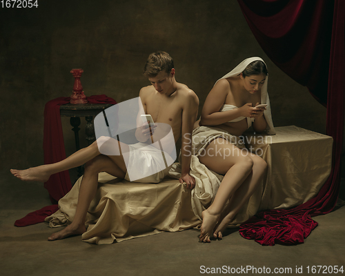 Image of Modern remake of classical artwork with modern tech theme - young medieval couple on dark background