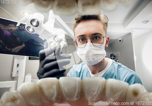 Image of Doctor looking into the mouth, checking, examining teeth