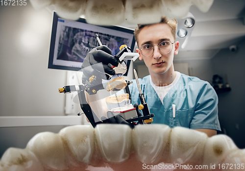 Image of Doctor looking into the mouth, checking, examining teeth