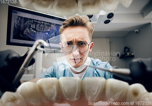 Image of Doctor looking into the mouth, checking, examining teeth