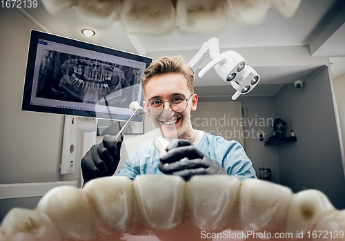 Image of Doctor looking into the mouth, checking, examining teeth