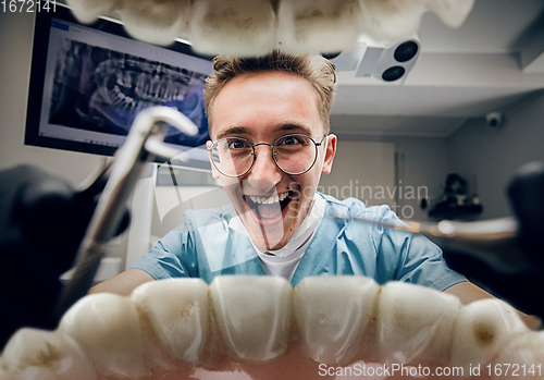 Image of Doctor looking into the mouth, checking, examining teeth