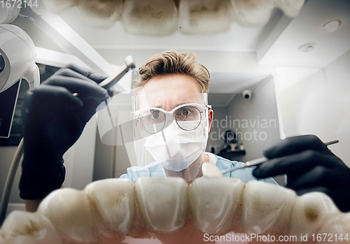 Image of Doctor looking into the mouth, checking, examining teeth