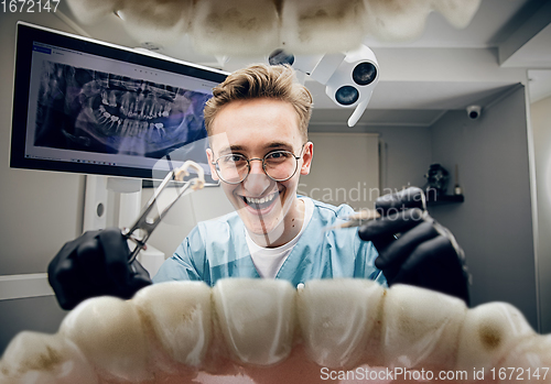 Image of Doctor looking into the mouth, checking, examining teeth