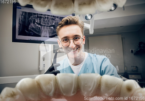 Image of Doctor looking into the mouth, checking, examining teeth