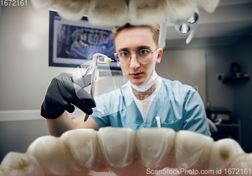 Image of Doctor looking into the mouth, checking, examining teeth