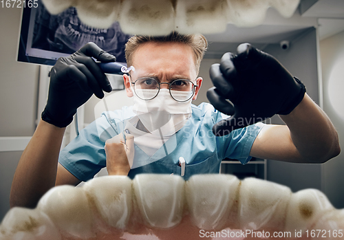 Image of Doctor looking into the mouth, checking, examining teeth