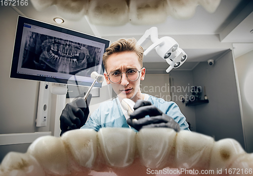 Image of Doctor looking into the mouth, checking, examining teeth