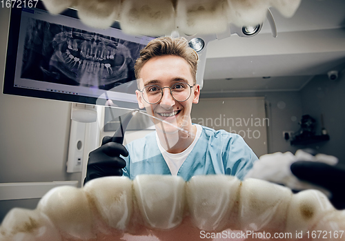 Image of Doctor looking into the mouth, checking, examining teeth