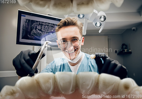 Image of Doctor looking into the mouth, checking, examining teeth