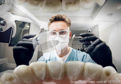 Image of Doctor looking into the mouth, checking, examining teeth