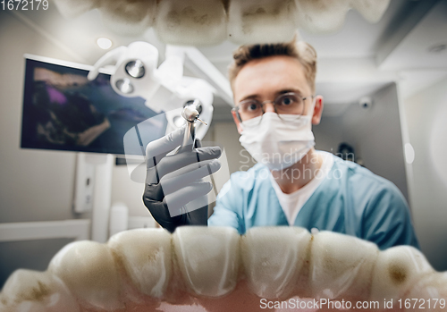 Image of Doctor looking into the mouth, checking, examining teeth