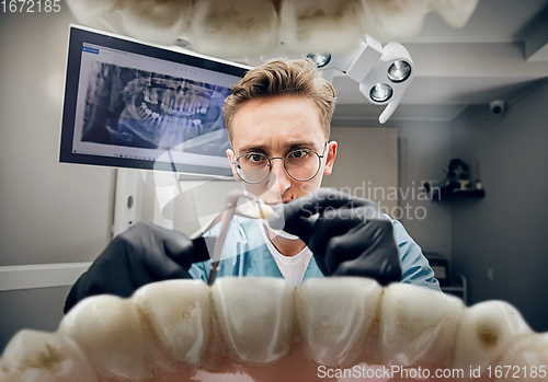 Image of Doctor looking into the mouth, checking, examining teeth