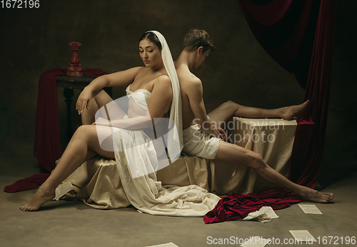 Image of Modern remake of classical artwork - young medieval couple on dark background, comparison of eras concept