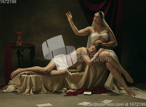 Image of Modern remake of classical artwork - young medieval couple on dark background, comparison of eras concept