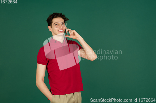 Image of Caucasian man\'s portrait isolated on green studio background with copyspace