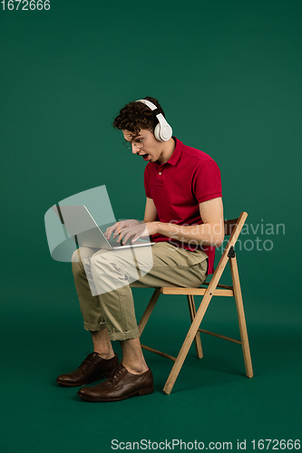 Image of Caucasian man\'s portrait isolated on green studio background with copyspace