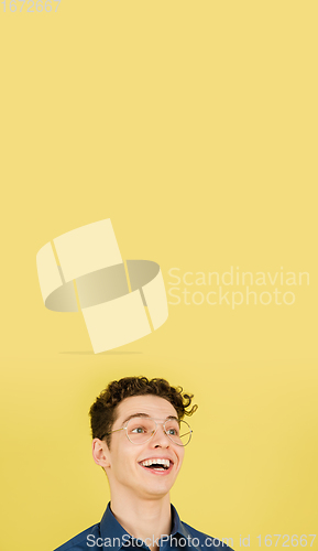 Image of Caucasian man\'s portrait isolated on yellow studio background with copyspace