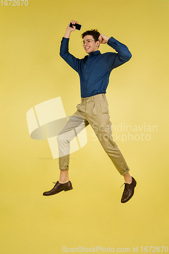 Image of Caucasian man\'s portrait isolated on yellow studio background with copyspace