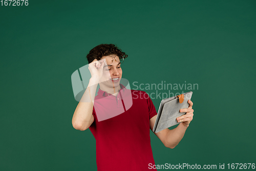 Image of Caucasian man\'s portrait isolated on green studio background with copyspace