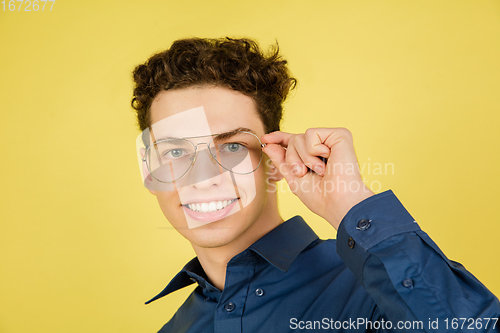 Image of Caucasian man\'s portrait isolated on yellow studio background with copyspace