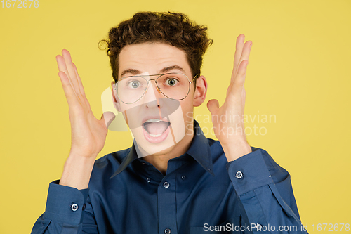 Image of Caucasian man\'s portrait isolated on yellow studio background with copyspace