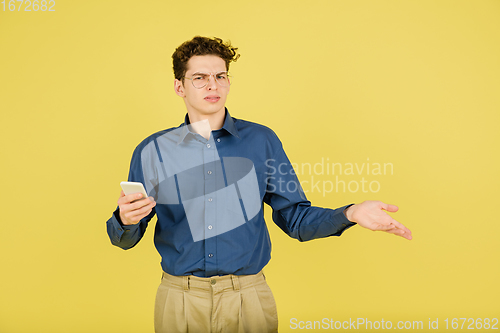 Image of Caucasian man\'s portrait isolated on yellow studio background with copyspace
