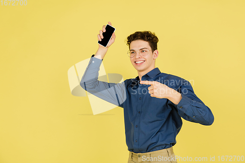 Image of Caucasian man\'s portrait isolated on yellow studio background with copyspace