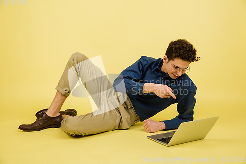 Image of Caucasian man\'s portrait isolated on yellow studio background with copyspace