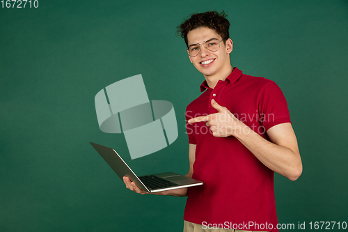 Image of Caucasian man\'s portrait isolated on green studio background with copyspace