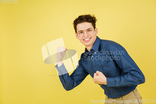 Image of Caucasian man\'s portrait isolated on yellow studio background with copyspace