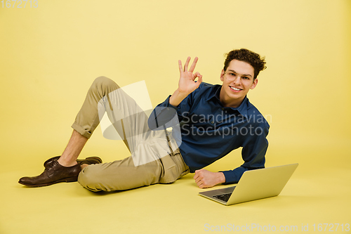 Image of Caucasian man\'s portrait isolated on yellow studio background with copyspace