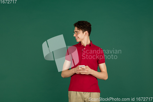 Image of Caucasian man\'s portrait isolated on green studio background with copyspace