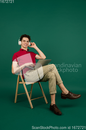 Image of Caucasian man\'s portrait isolated on green studio background with copyspace